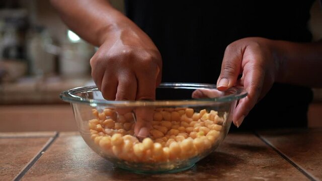 Mashing chickpeas to be added to a homemade vegan recipe - slow motion