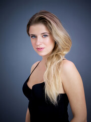 Fototapeta premium Portrait of nice pretty blonde lady isolated over grey background. Beauty and lifestyle concepts