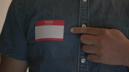 Close Up of a Man Pointing to a Blank Name Tag