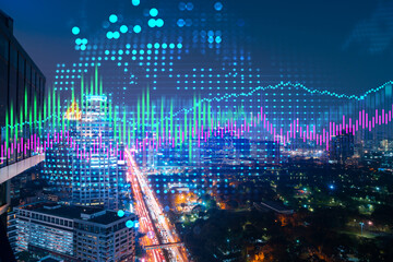 Stock market graph hologram, night panorama city view of Bangkok, popular location to gain financial education in Asia. The concept of international research. Double exposure.