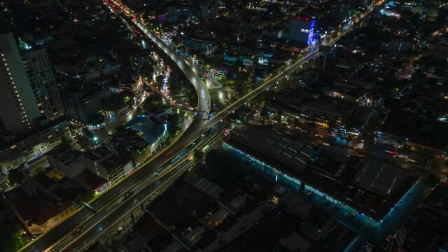 Aerial nighttime hyperlapse of a busy intersection in Mexico City, circle pan