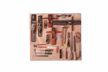 Traditional carpentry tools on wooden background.