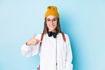 Young student woman isolated person pointing by hand to a shirt copy space, proud and confident