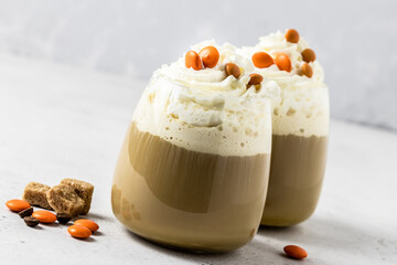 Party drink, whipped cream coffee in glass. Selective focus, copy space.