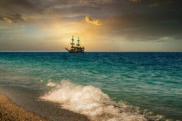Ocean sunset and sail ship
