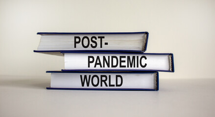 Books with text 'post-pandemic world' on beautiful white background. Business and post-pandemic concept. Copy space.