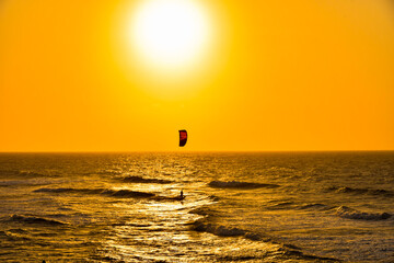 Einsamer Surfer bei Sonnenuntergang am Meer