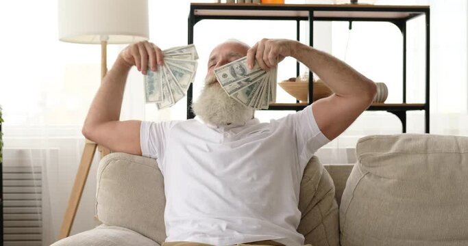 Senior man feeling delighted and stress free with huge amount of cash in hands