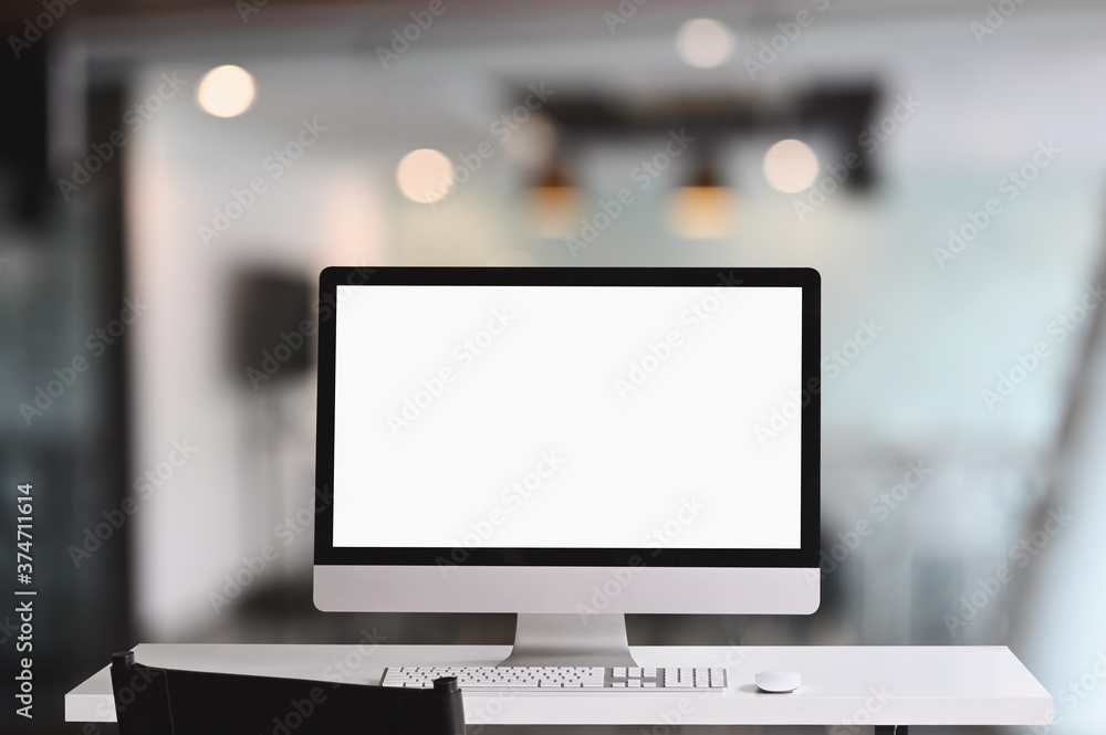 Poster workspace computer monitor with a white blank screen on white table.