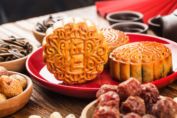 Mid-Autumn Festival concept, Traditional mooncakes on table  with teacup.Chinese translation on moon cake: Nuts
