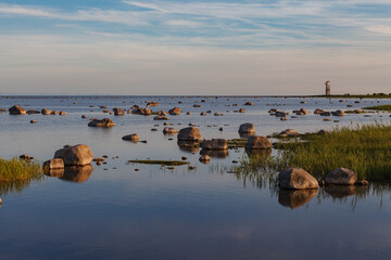 Rugged rocky coast on the island of Saaremaa in Estonia with Baltic Sea washing up on shore.