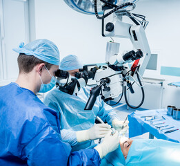 A team of surgeons performing brain surgery to remove a tumor.