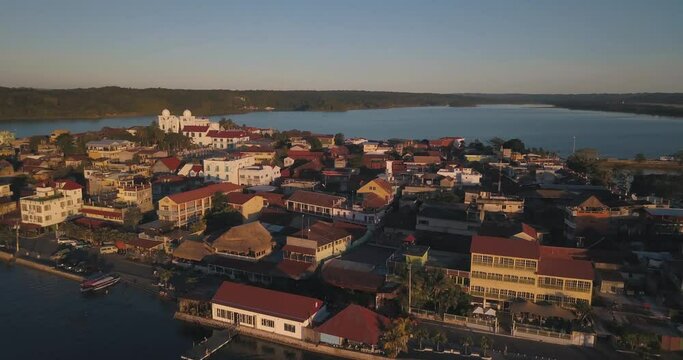 Aerial drone shot of an island during sunset at the lake of flores peten, Guatemala