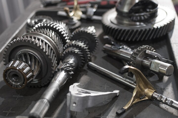 parts of an automotive manual transmission on a table in a car service. Close up