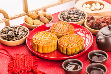 Mid-Autumn Festival concept, Traditional mooncakes on table  with teacup.Chinese translation on moon cake: Nuts