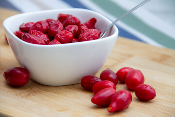 red dogwood berries in a white bowl