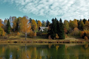 An old house on the bank of the river. Moscow region. Russia.
