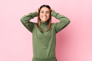 Young caucasian woman isolated laughs joyfully keeping hands on head. Happiness concept.