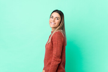 Fototapeta premium Young caucasian woman isolated looks aside smiling, cheerful and pleasant.