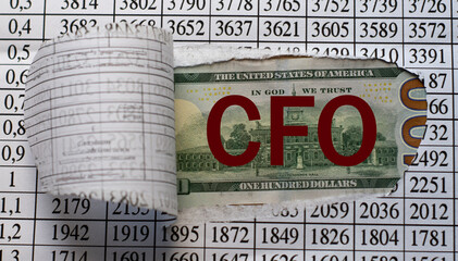 CFO is the word behind torn office paper with numbers