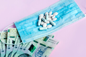 Pills, Ukrainian money and a protective medical dressing. Health concept.