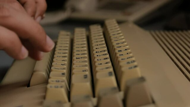 Typing on old computer (close up)