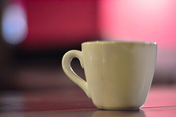 Close up White coffee cup on wooden table in cafe with blur background. Modern cafe concept