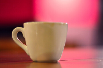 Close up White coffee cup on wooden table in cafe with blur background. Modern cafe concept
