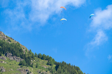 Paragliders in the sky over the mountain. Paragliding is an extreme sport