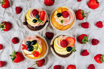 chocolate cupcakes with cream and fresh berries