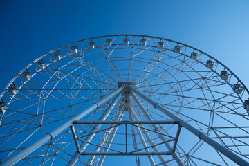 Ferris wheel on the background of blue sky