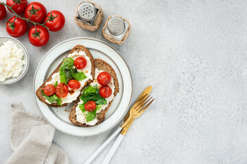 Healthy italian bruschetta with ricotta cheese, romaine lettuce and roasted cherry tomatoes. Table...