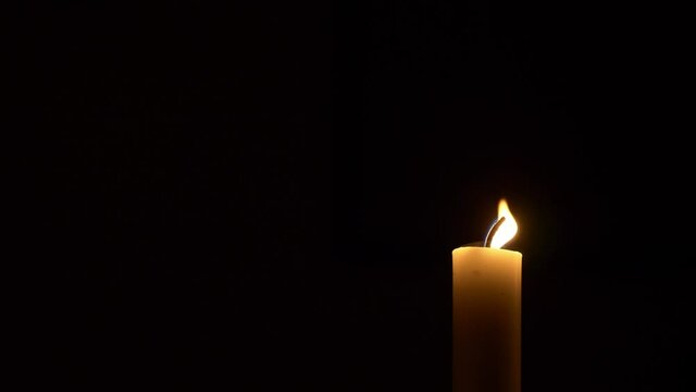 video of wax candle on a dark background