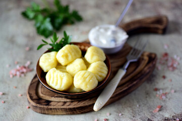 Delicious lunch: Potato gnocchi with mushroom sauce on a gray background