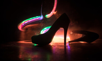 Silhouette of a high heel women shoes at dark. Women power or women domination concept.