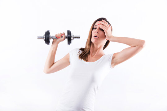 Exhausted woman lifting weight