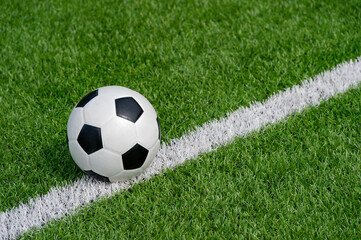 Black and white soccer ball in the field. Team sport concept. Workout online theme.