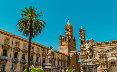 Fototapeta na wymiar The beautiful Arab Norman Cathedral in Palermo, Sicily, Italy with palm tree
