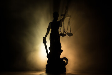 The Statue of Justice - lady justice or Iustitia / Justitia the Roman goddess of Justice on a dark...