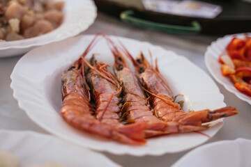 prawns on a white plate to prepare a typical Spanish seafood paella