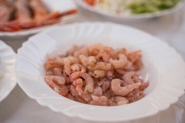 prawns on a white plate to prepare a typical Spanish seafood paella