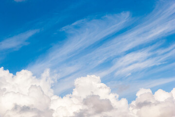 cumulus and high-cumulus clouds of an average tier on blue heavenly space