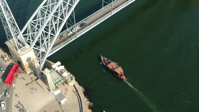 Boat going under the bridge over the river