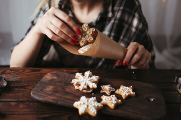 Christmas bakery. Woman packing Christmas gingerbread cookies. Festive food, sweet present, family...