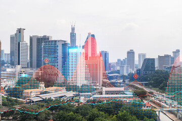 Forex and stock market chart hologram over panorama city view of Kuala Lumpur. KL is the financial center in Malaysia, Asia. The concept of international trading. Double exposure.