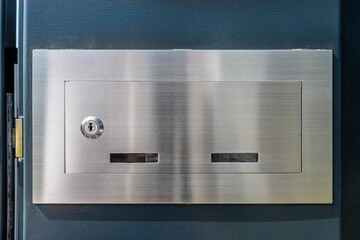 A metal letterbox placed in a modern panel fence in panel fence in anthracite color.