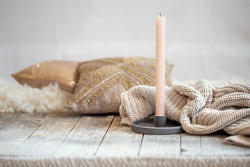 Fototapeta na wymiar Background with a cozy knitted sweater and a candle.