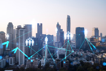 Fototapeta na wymiar Hologram of social media icons over sunset panoramic cityscape of Bangkok, Asia. The concept of people connections. Multi exposure.
