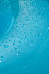 close-up of drops on a blue surface