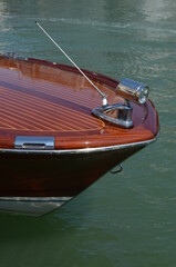 
bow of a motorboat in polished wood with chrome details